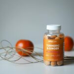 Vibrant still life of turmeric and ginger gummies with fresh oranges.